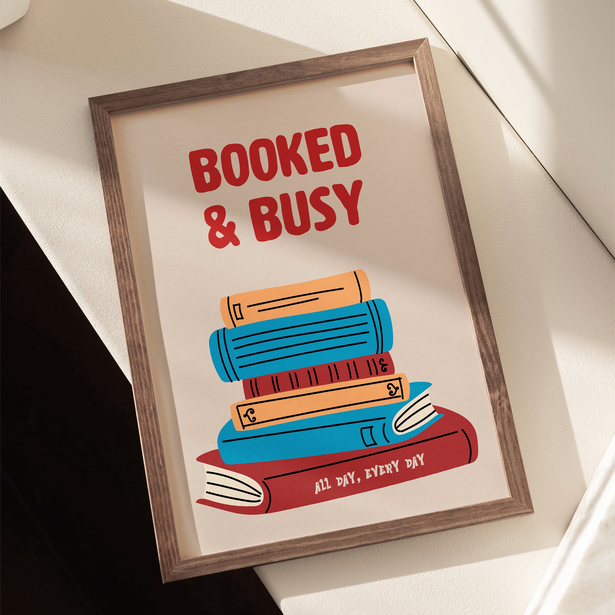 Print of stacked books with "Booked & Busy" text, perfect for reading nook